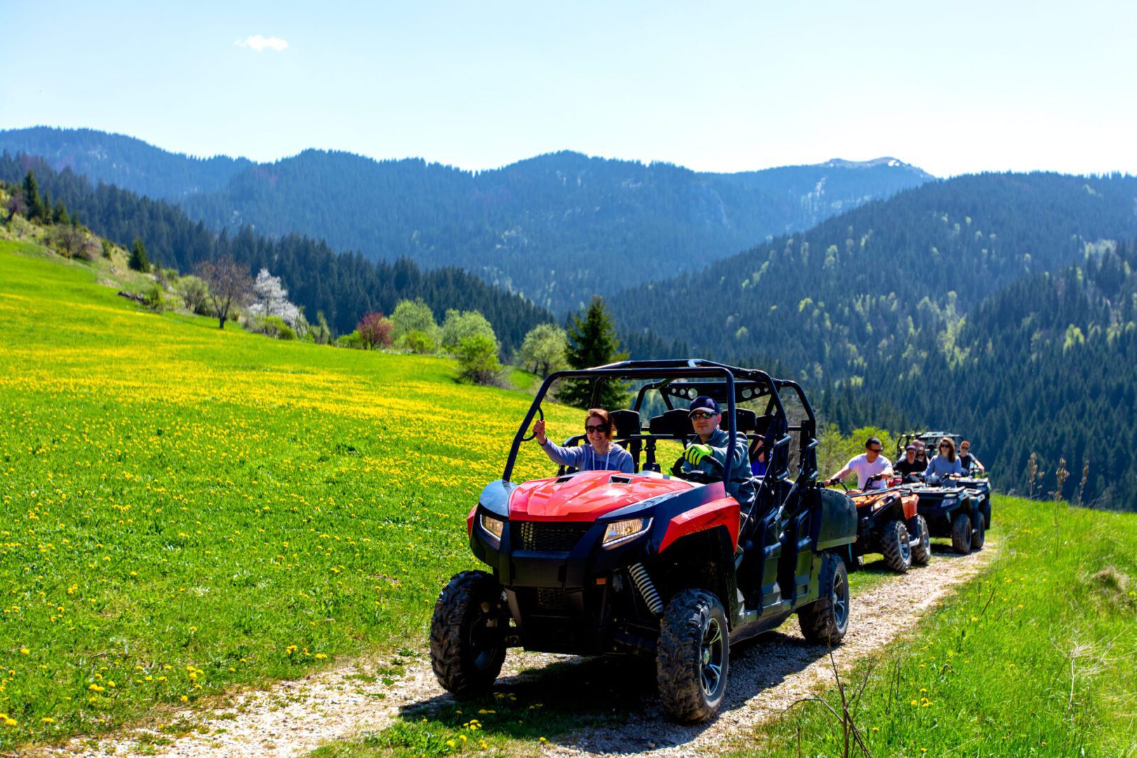 A group of people riding on the back of an atv.