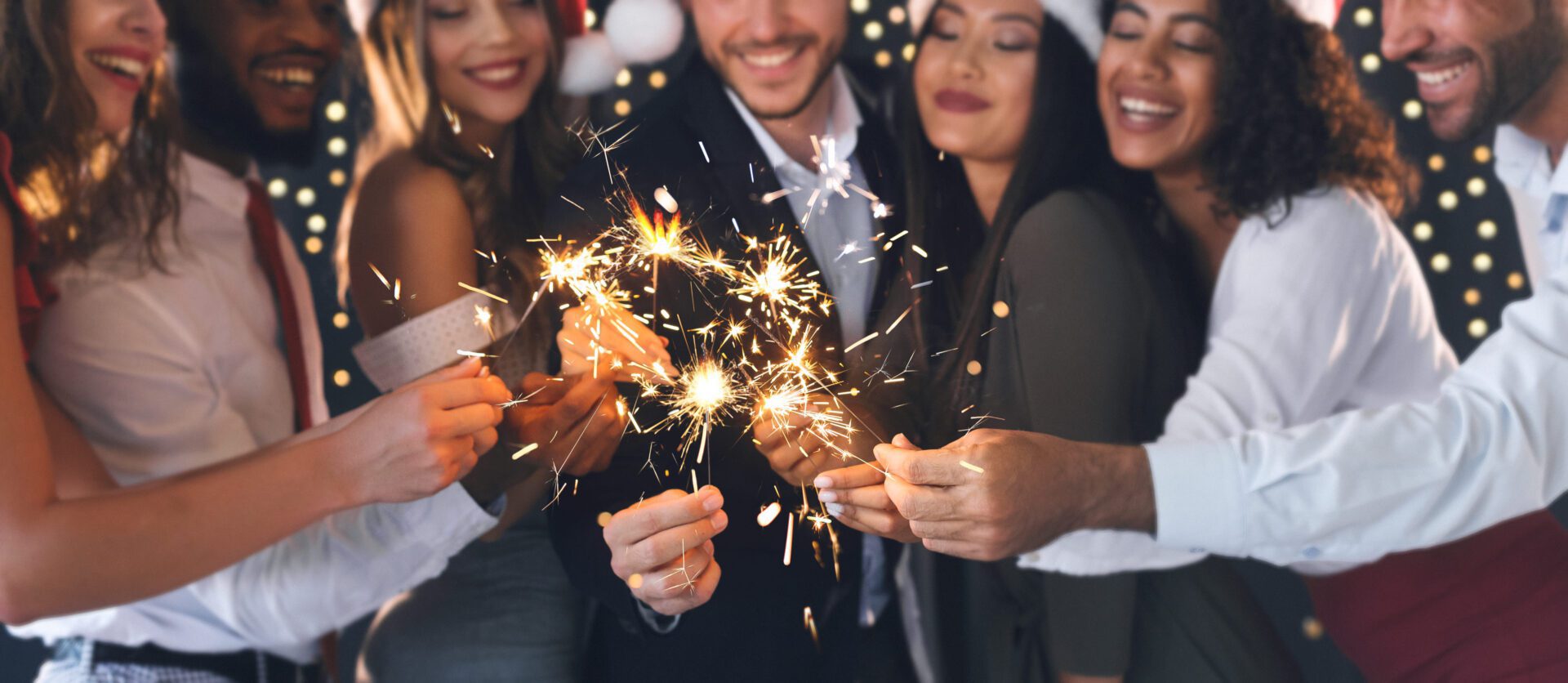 A group of people holding sparklers in their hands.