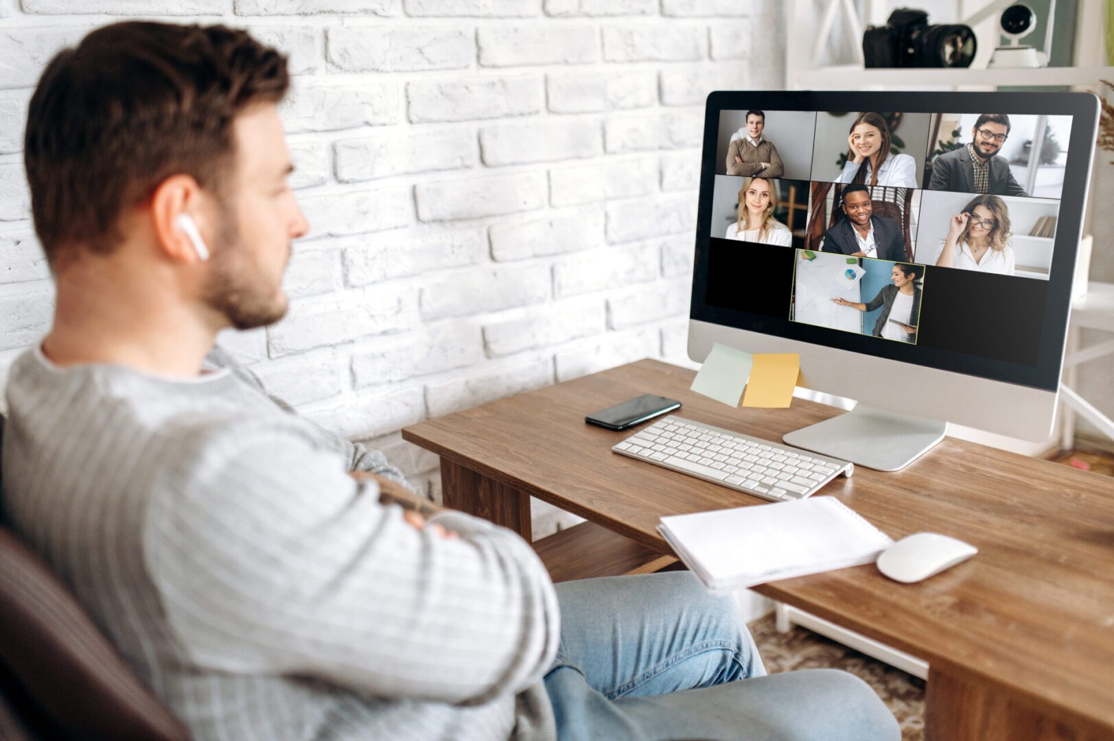 A man sitting in front of a computer screen.