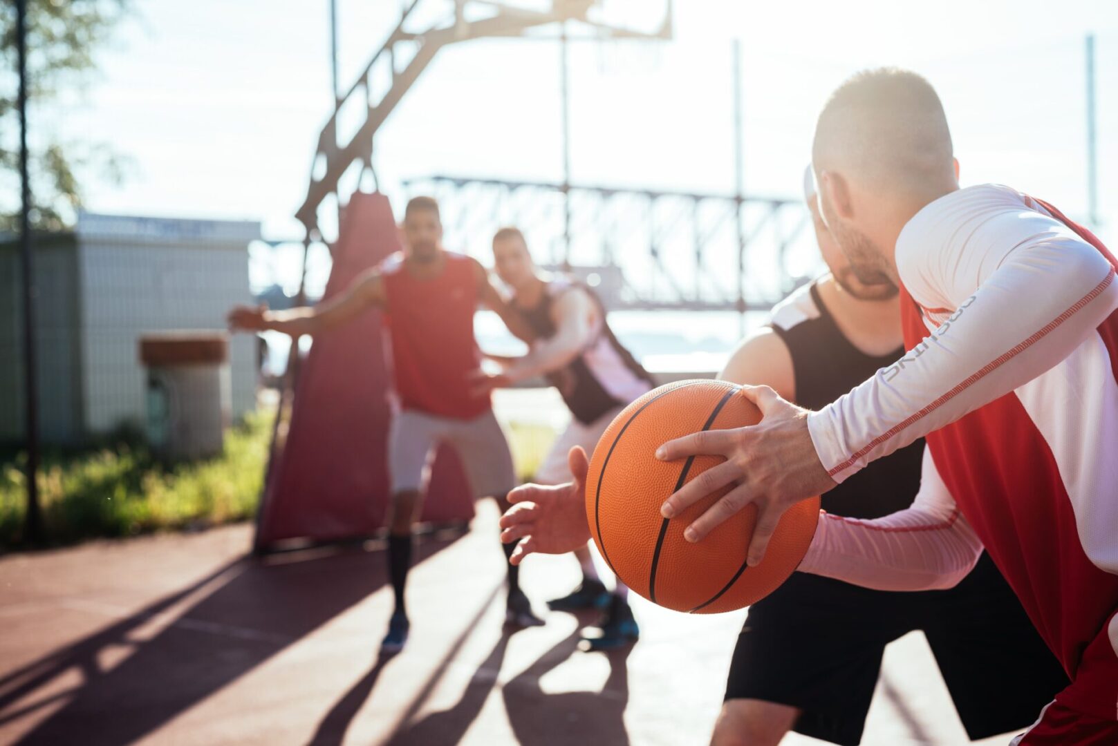 A group of men playing basketball on a court.