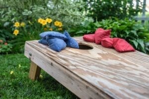 a garden bench with red and blue pillows