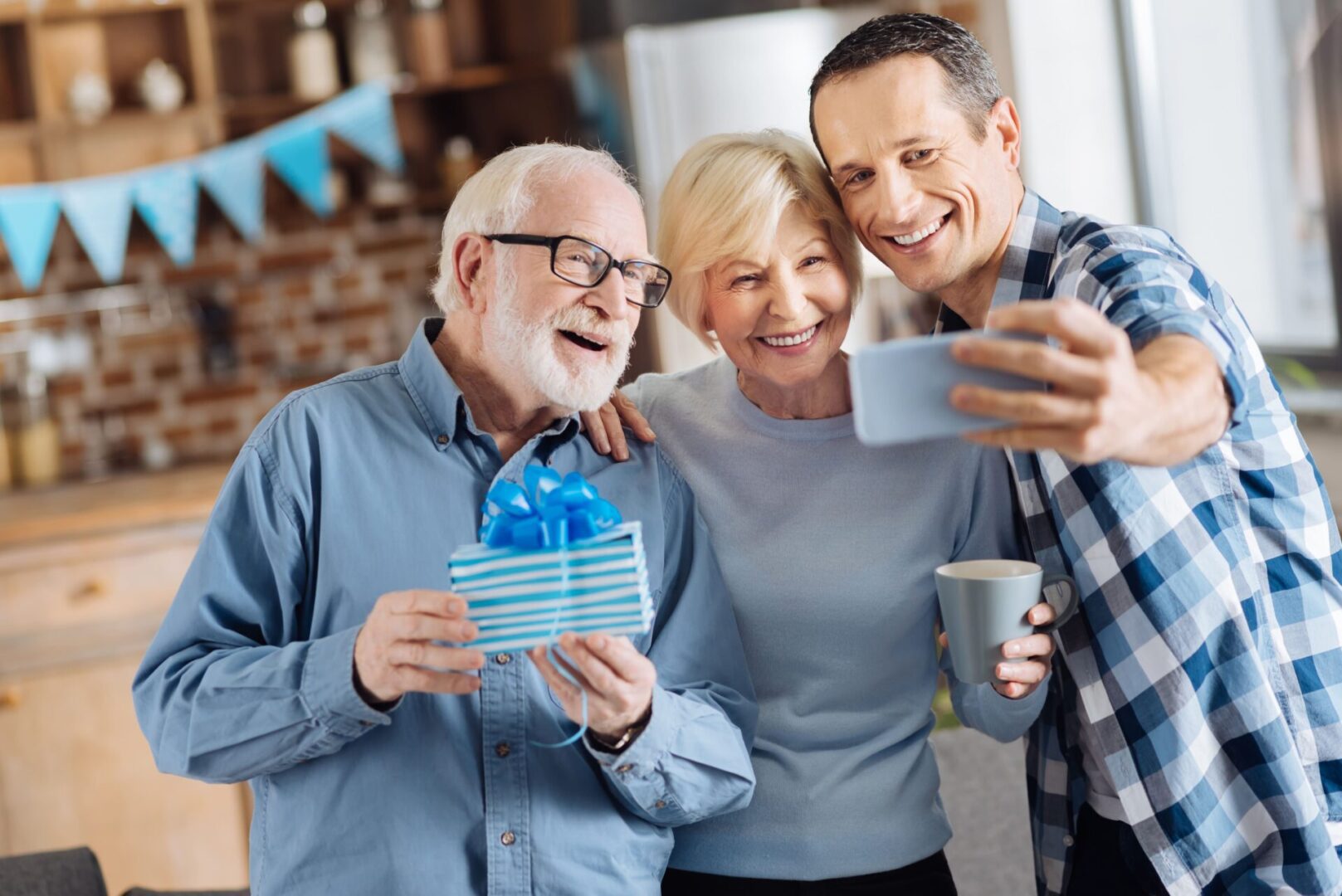 A group of people taking a selfie with a gift.