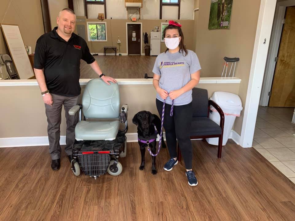 A wheel chair donation to paws for purple hearts