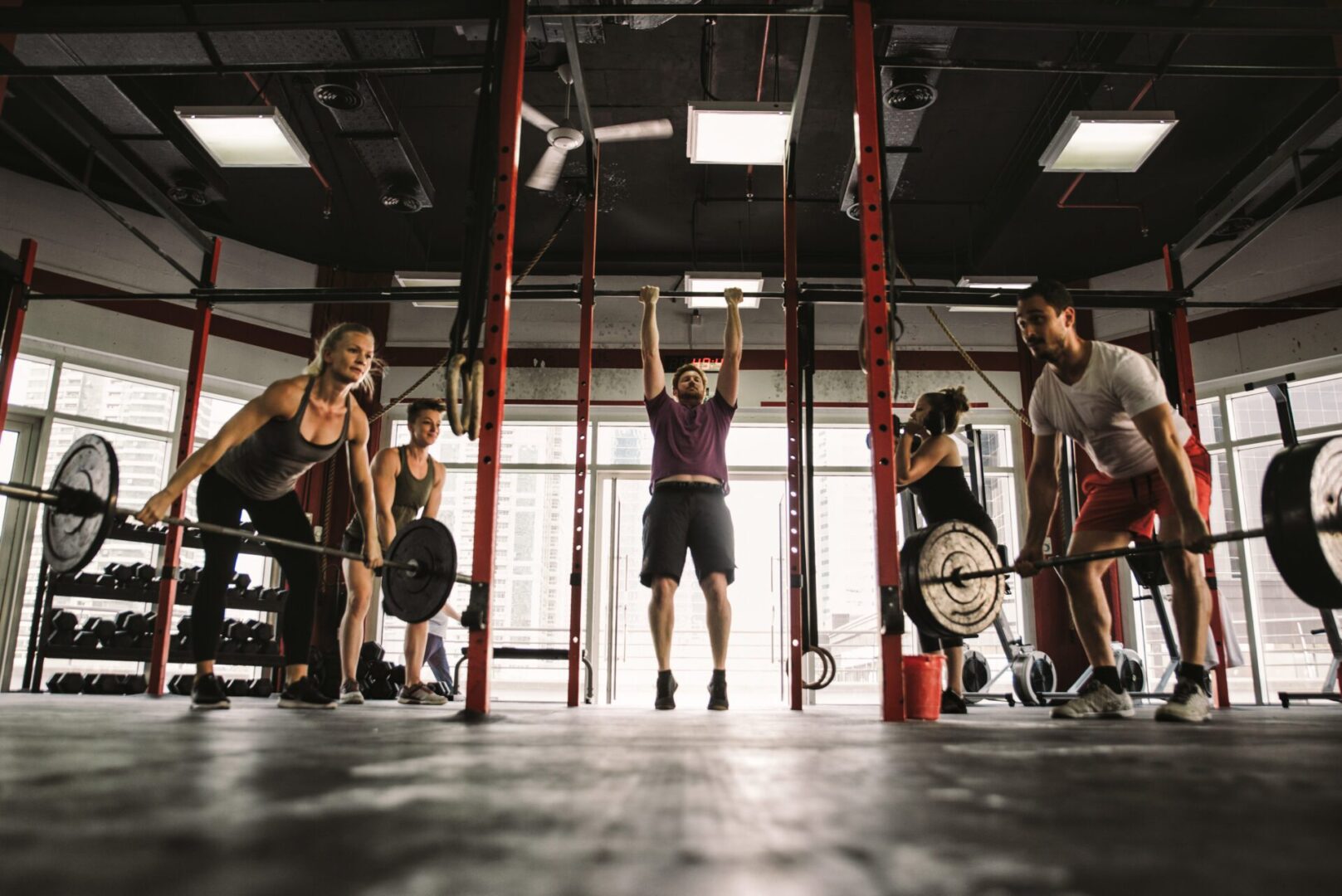 A group of people in the gym doing exercises.