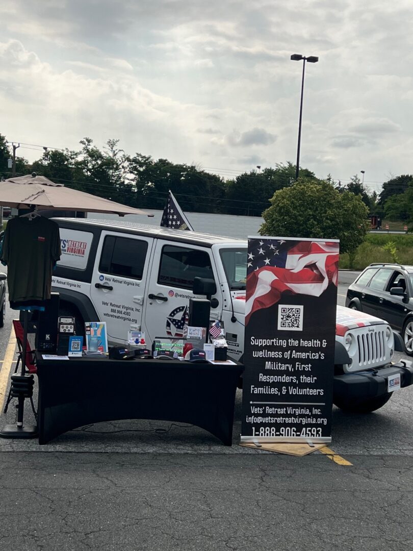 A table with an american flag on it in front of a jeep.