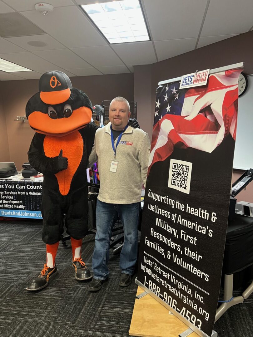A man standing next to a mascot and an american flag.