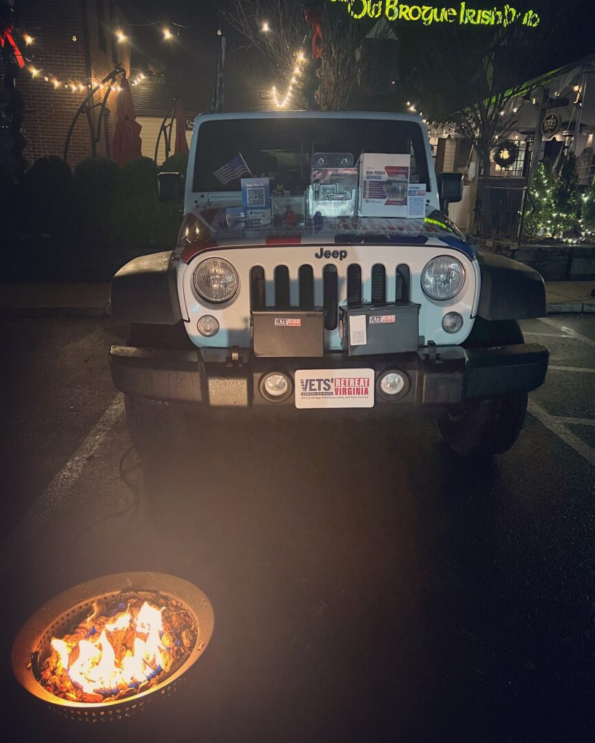 A jeep parked in front of a fire pit.