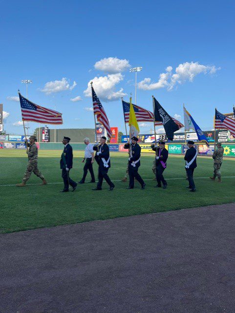 Color guard marching with American flags.