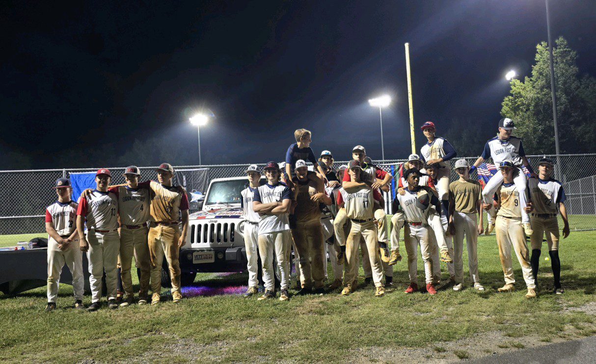 Baseball team celebrating victory at night.