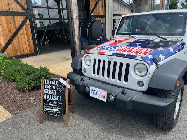 White Jeep with American flag decal.