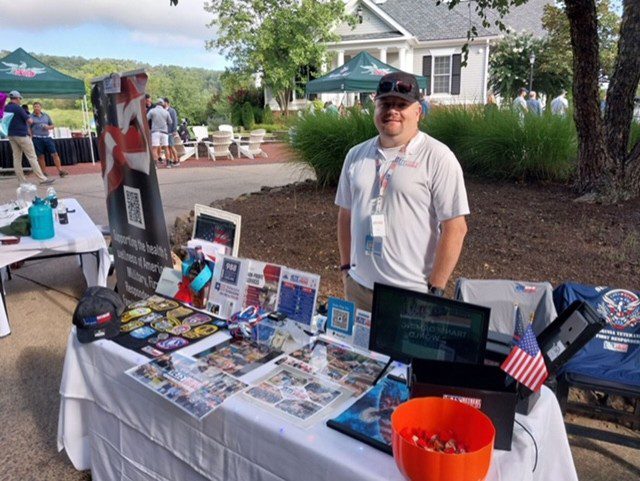 Man at a military support booth.