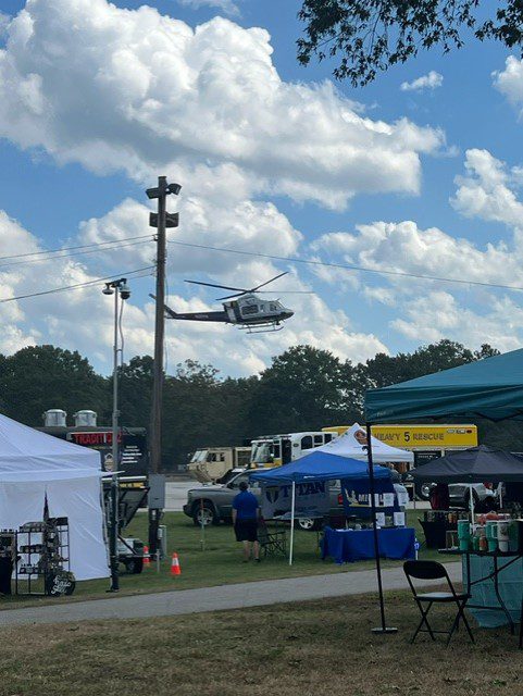 Helicopter flying over a festival.