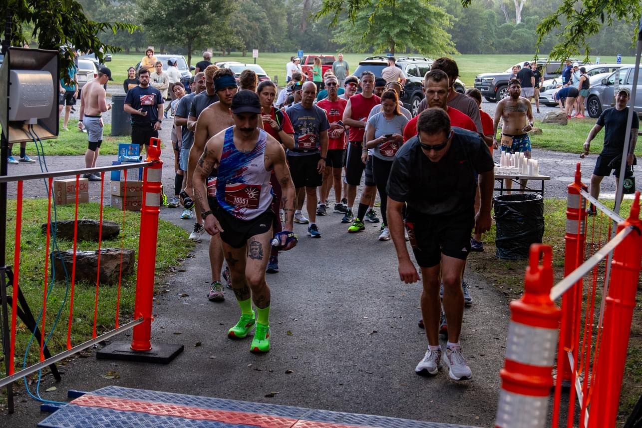 Runners cross finish line in a race.